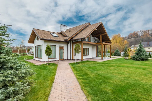 Contemporary cottage exterior with a landscaped yard.